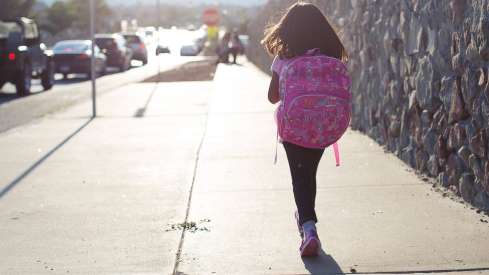 A girl is pictured walking to school in this stock image.
