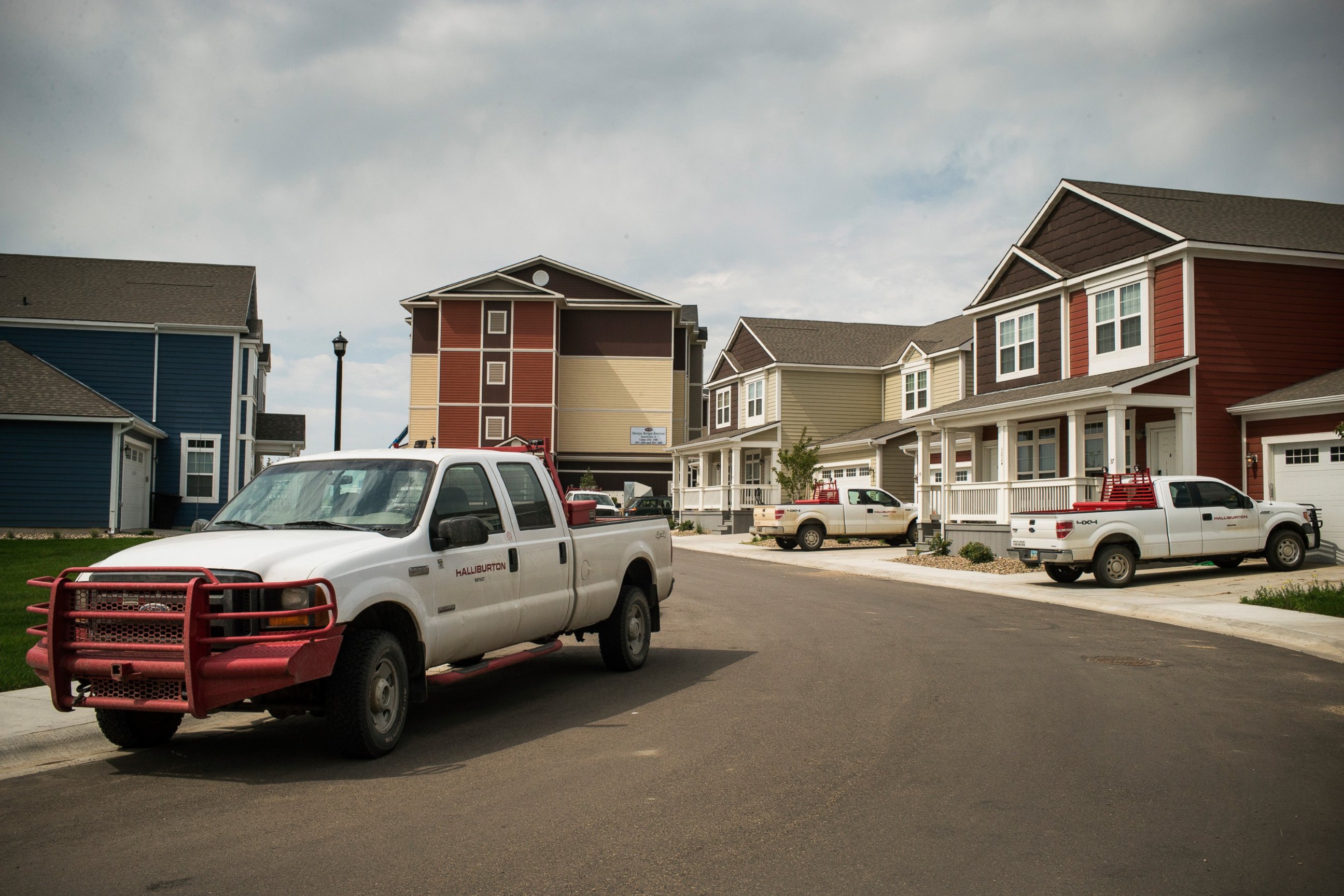 PHOTO: Trucks are parked near new homes rented by oil workers, July 28, 2013, in Williston, North Dakota.  