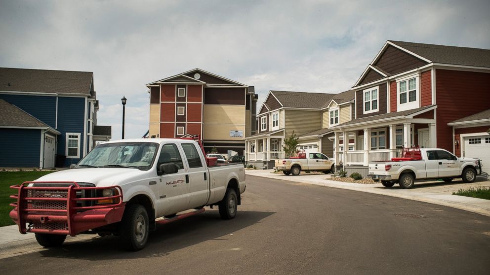 PHOTO: Trucks are parked near new homes rented by oil workers, July 28, 2013, in Williston, North Dakota.  