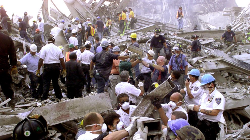 Rescue workers remove rubble at the World Trade Center after it was struck by a commercial airliner in a terrorist attack.