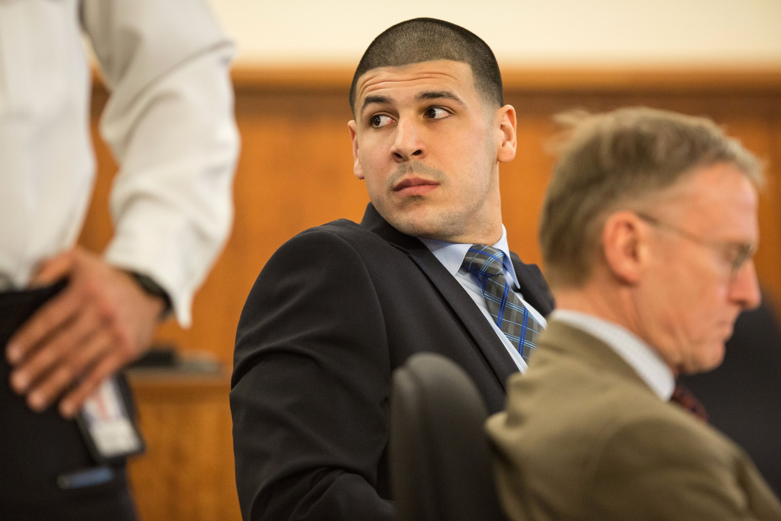 PHOTO:Aaron Hernandez watches as Robert Kraft entered the courtroom during the murder trial of former New England Patriots tight end at Bristol County Superior Court in Fall River, Mass., March 31, 2015.  