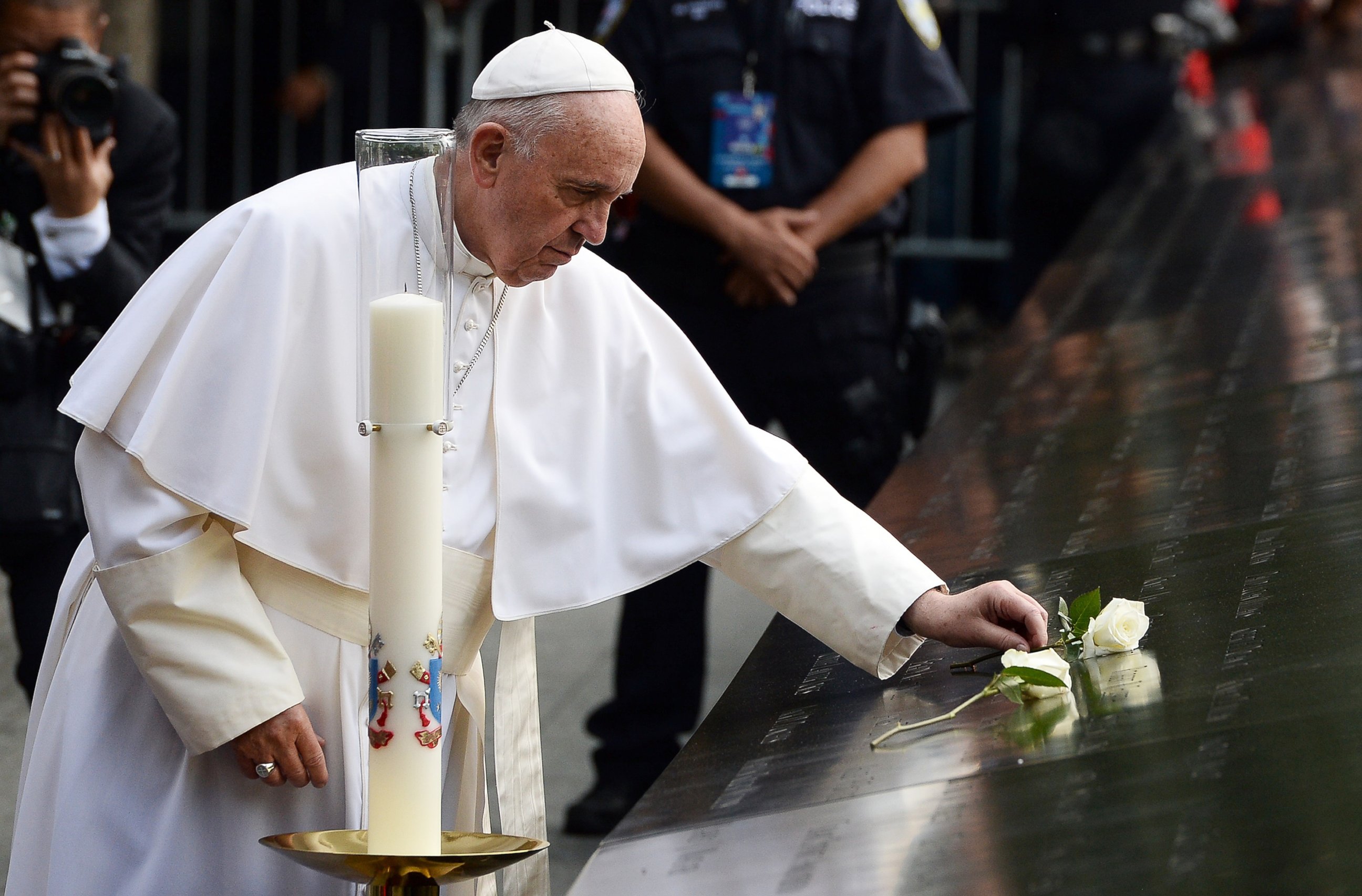 PHOTO:Pope Francis places a white rose on the names of the September 11 victims at the edge of the South Pool of the 9/11 memorial in New York, Sept. 25, 2015.  