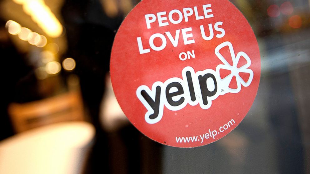 The Yelp Inc. logo is displayed in the window of a restaurant in New York, March 1, 2012.