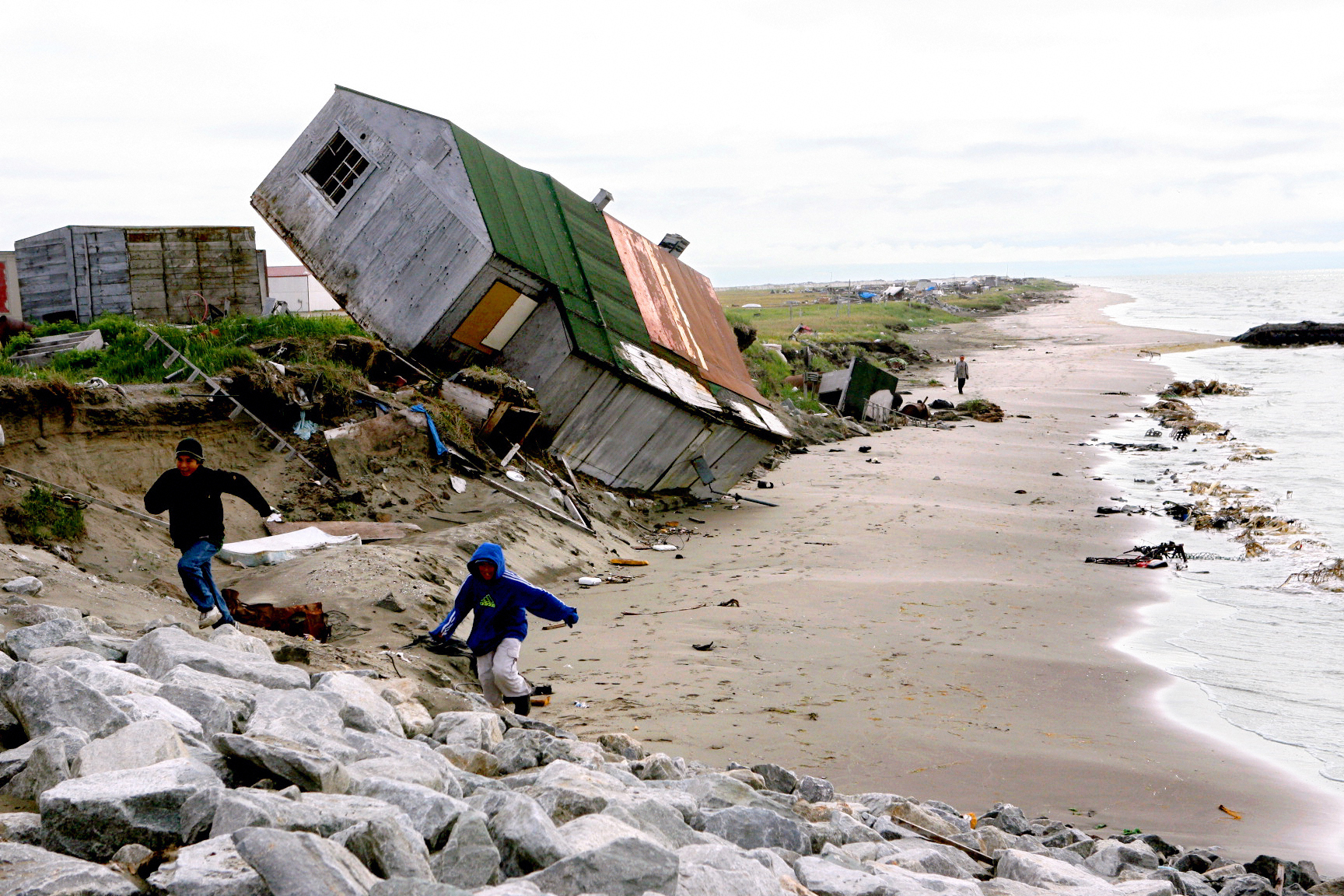 PHOTO: A home destroyed by beach erosion tips over in the the Alaskan village of Shishmaref, Sept. 27, 2006. 