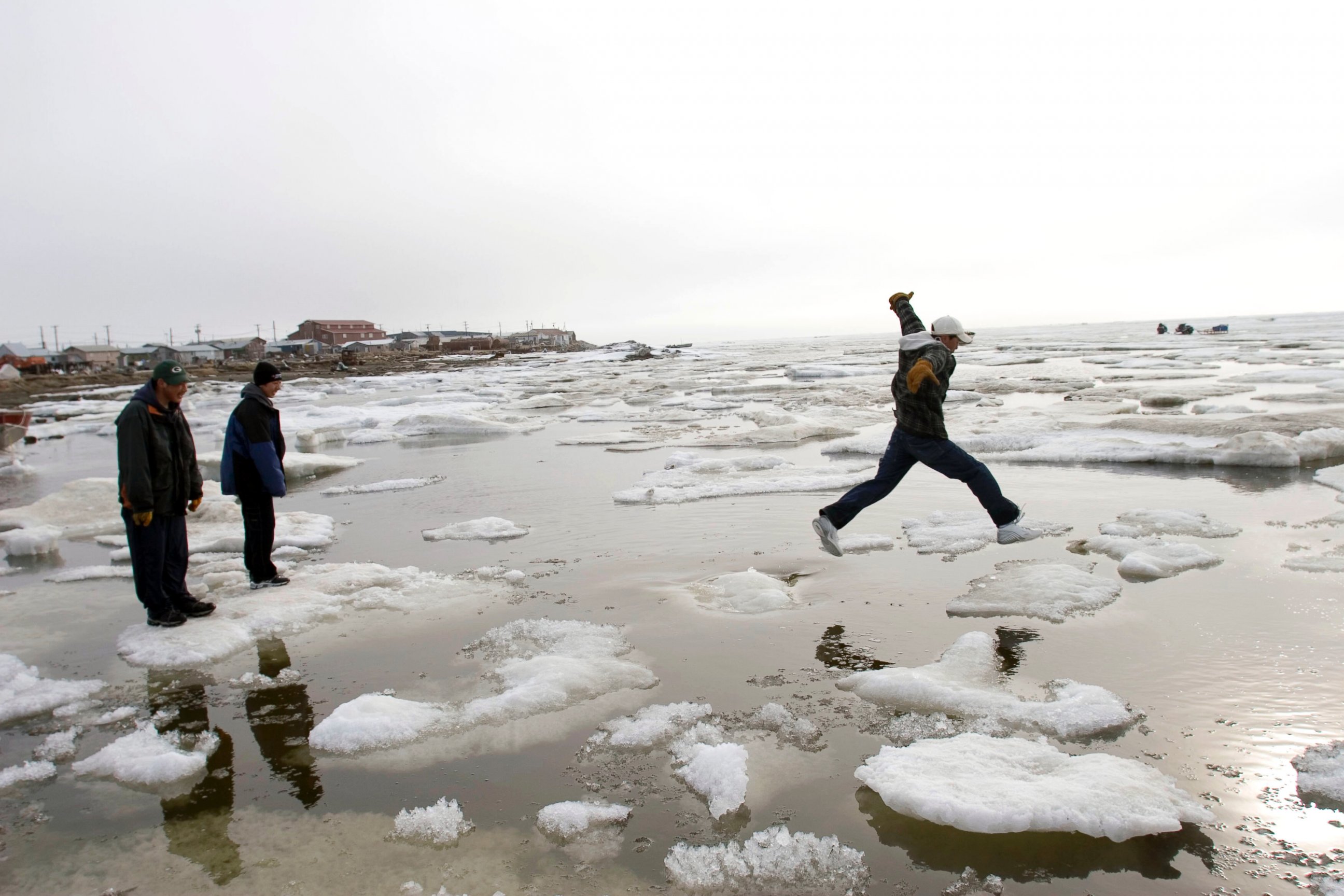 PHOTO: Teenage Inupiat Eskimos go ice-hoping on the Chukchi Sea at 1 am, one of the rare distractions in Shishmaref, June 10, 2005, in Shishmaref, Alaska.