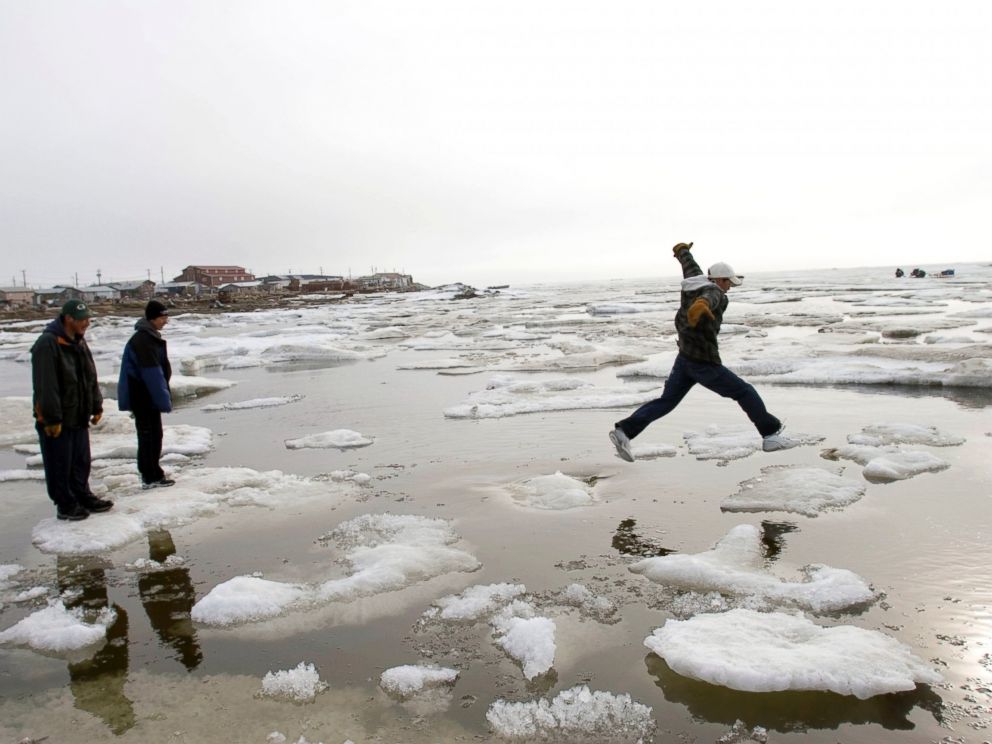 PHOTO: Teenage Inupiat Eskimos go ice-hoping on the Chukchi Sea at 1 am, one of the rare distractions in Shishmaref, June 10, 2005, in Shishmaref, Alaska.