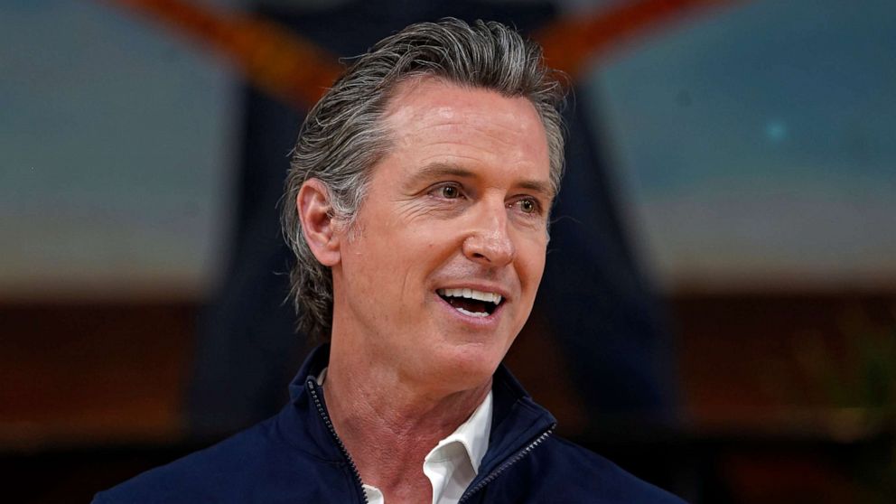 PHOTO: California Gov. Gavin Newsom takes questions from the media during a visit to a mobile vaccination site at Ramona Gardens Recreation Center in Los Angeles, Sunday, Feb. 21, 2021. 