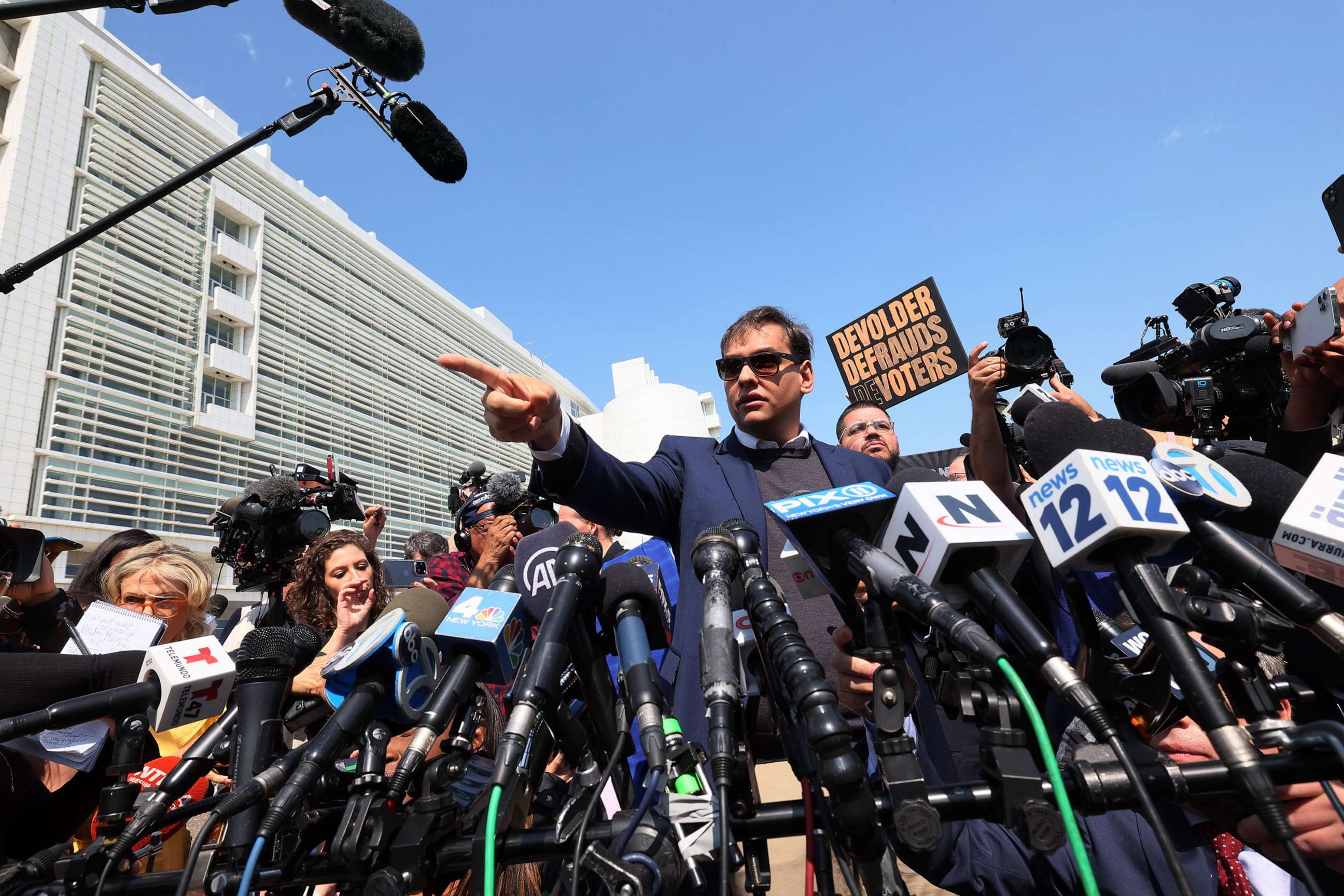 PHOTO: Rep. George Santos (R-NY) speaks with members of the press as he leaves Federal Court, May 10, 2023, in Central Islip, N.Y.
