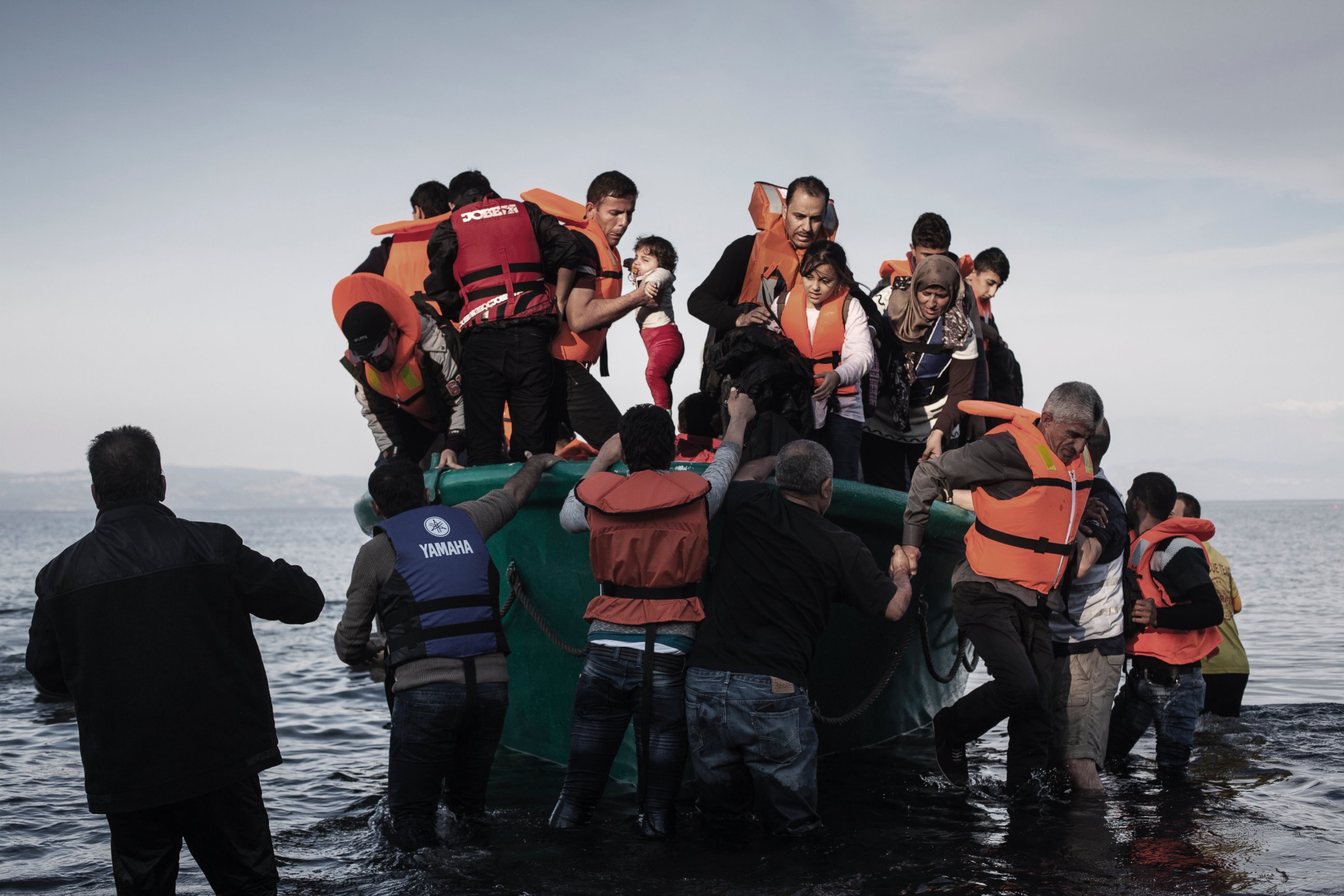 PHOTO: Refugees from Afghanistan and Syria disembark from a life boat on the shores of Lesbos near Skala Sikaminias, Greece, Nov. 10, 2015. 