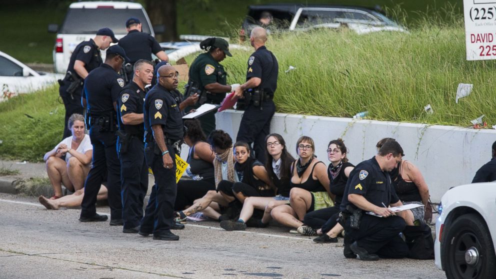 PHOTO: Several arrested protesters get processed on the scene after a march on July 10, 2016 in Baton Rouge, Louisiana.