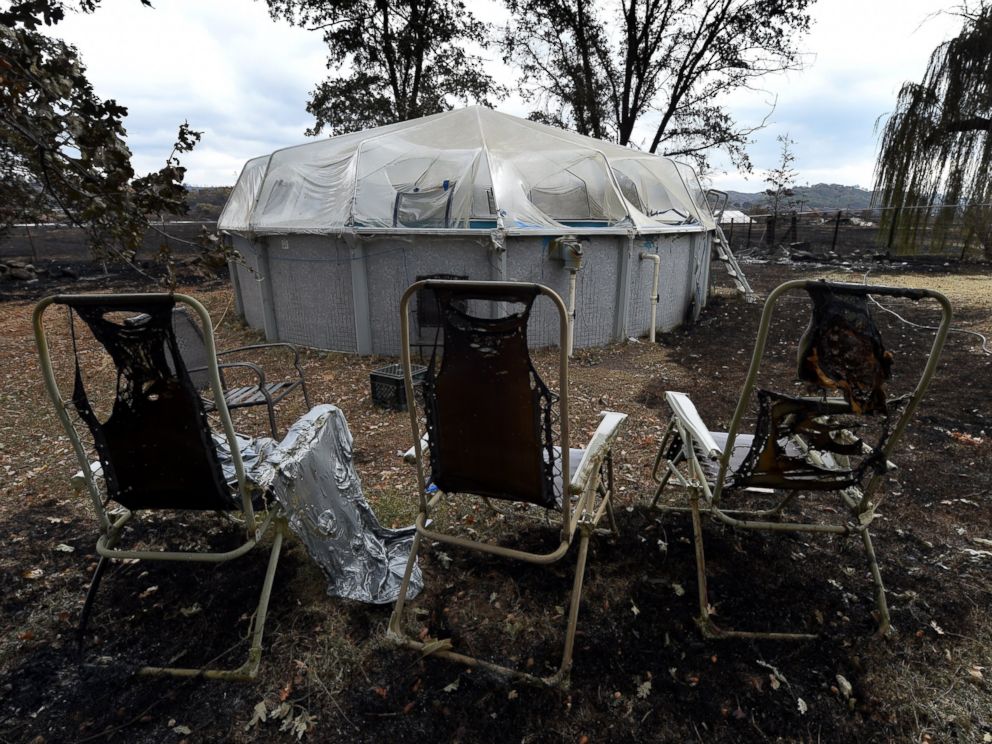 PHOTO: Burnt chairs stand in front of a swimming pool beside a fire destroyed house after the Valley Fire swept through the town of Middletown, California, on September 16, 2015. 