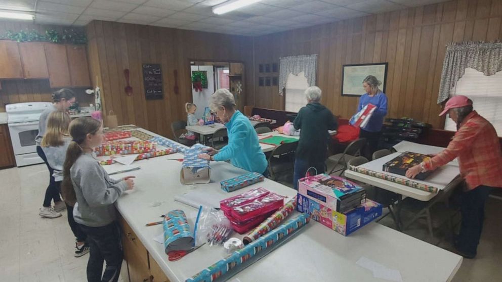 PHOTO: Shawn Triplett and local volunteers wrap Holiday gifts near Mayfield, Kentucky.