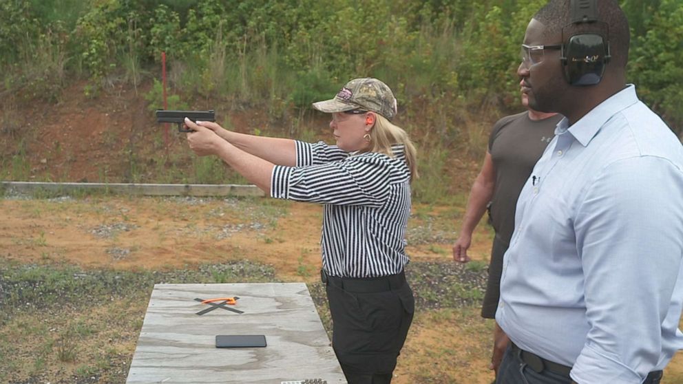 PHOTO: Ginger Chandler, the co-founder of LodeStar Works, firing one of the company's smart guns.