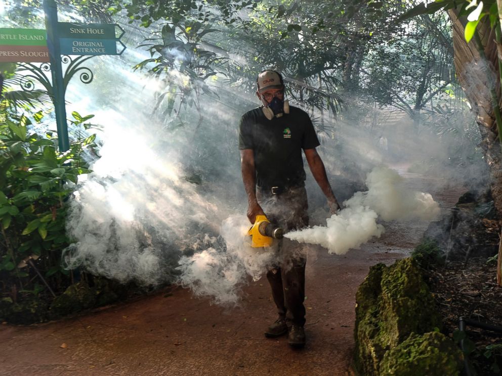 PHOTO: A grounds keeper at Pinecrest Gardens, former home of the historic Parrot Jungle,  uses a blower to spray pesticide to kill mosquitos Aug. 4, 2016 in Miami