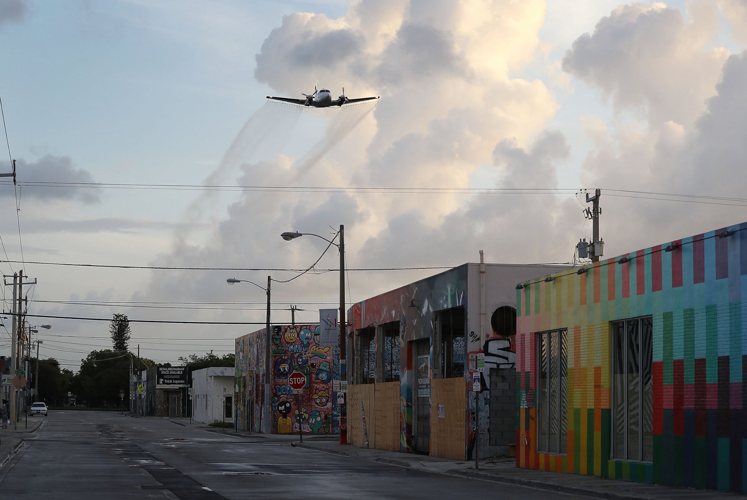 PHOTO:  A plane sprays pesticide over the Wynwood neighborhood in the hope of controlling and reducing the number of mosquitos, some of which may be capable of spreading the Zika virus