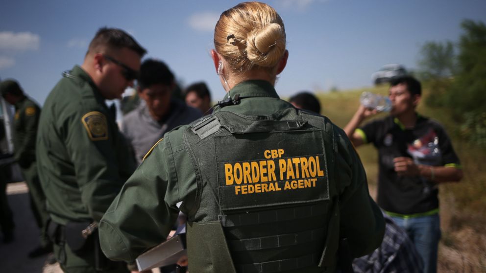 U.S. Border Patrol agents detain undocumented immigrants after they crossed the border from Mexico into the United States , Aug. 7, 2015, in McAllen, Texas. 