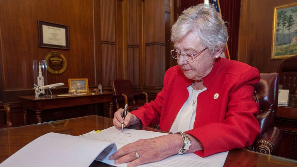 PHOTO: Alabama Governor Kay Ivey signs the Alabama Human Life Protection Act, after both houses of the Alabama Legislature passed HB314, May 15, 2019. 