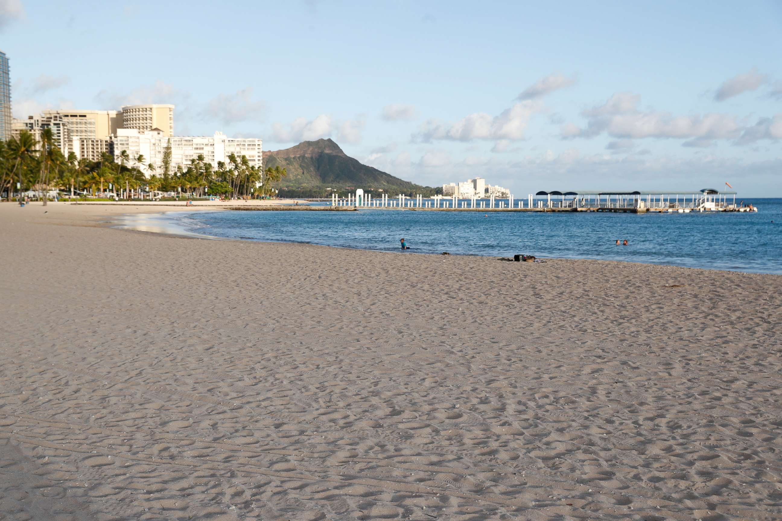FILE PHOTO: Waikiki Beach is nearly empty due to the business downturn caused by the coronavirus disease (COVID-19) in Honolulu, Hawaii, U.S. April 28, 2020. Picture taken April 28, 2020.