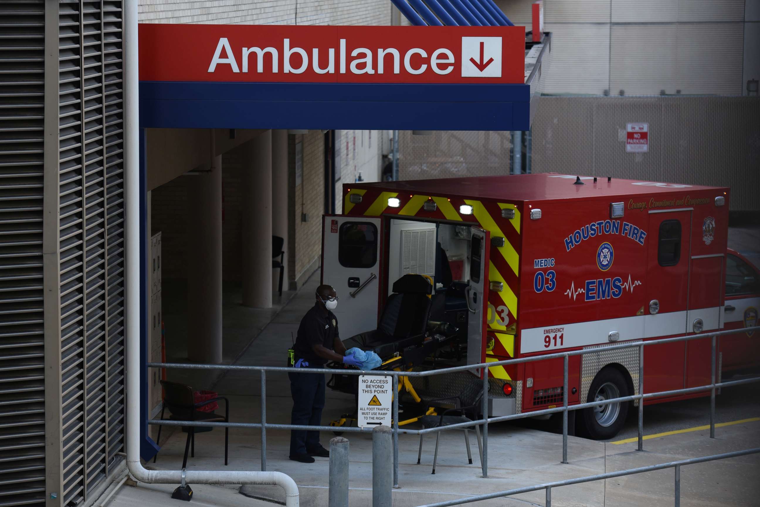 PHOTO: A healthcare worker places a stretcher inside of an ambulance at the emergency room entrance of Houston Methodist Hospital in the Texas Medical Center as cases of the coronavirus disease (COVID-19) spike in Houston, Texas, U.S., July 8, 2020.  