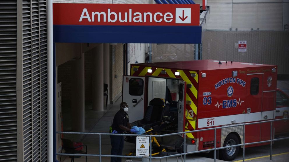 PHOTO: A healthcare worker places a stretcher inside of an ambulance at the emergency room entrance of Houston Methodist Hospital in the Texas Medical Center as cases of the coronavirus disease (COVID-19) spike in Houston, Texas, U.S., July 8, 2020.