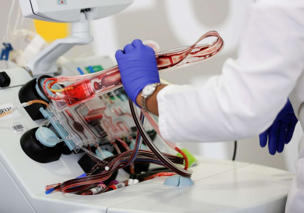 FILE PHOTO: Phlebotomist Jenee Wilson takes apart an aphaeresis kit after processing a convalescent plasma donation from a recovered coronavirus patient at the Central Seattle Donor Center of Bloodworks Northwest in Seattle, Washington, on April 17, 2020.