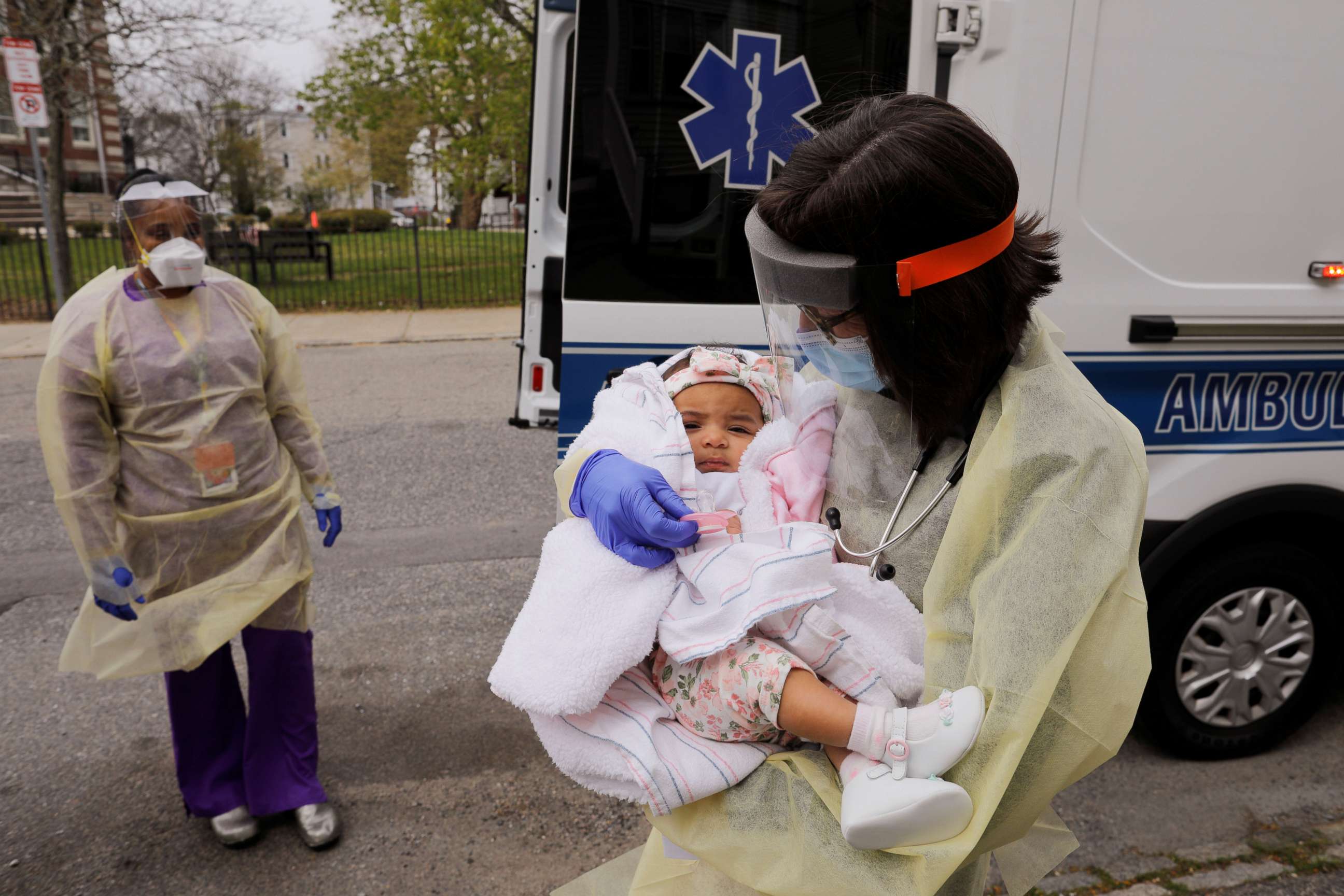 PHOTO: Boston Medical Center pediatrician Dr. Sara Stulac holds five month-old Nairobi Kyra Osorio before Dr. Stulac and nurse Angelee Bullock perform a routine check-up in an ambulance in front of Osorio's home in Boston, Massachusetts, on May 8, 2020.