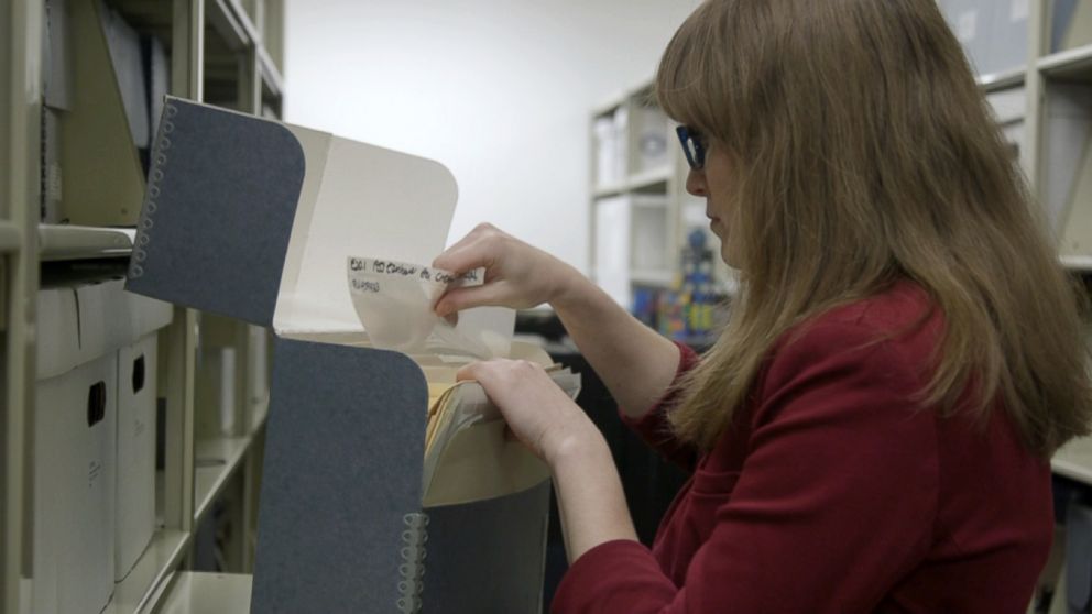 PHOTO: Historian Samantha Bradbeer looking through company archive. 