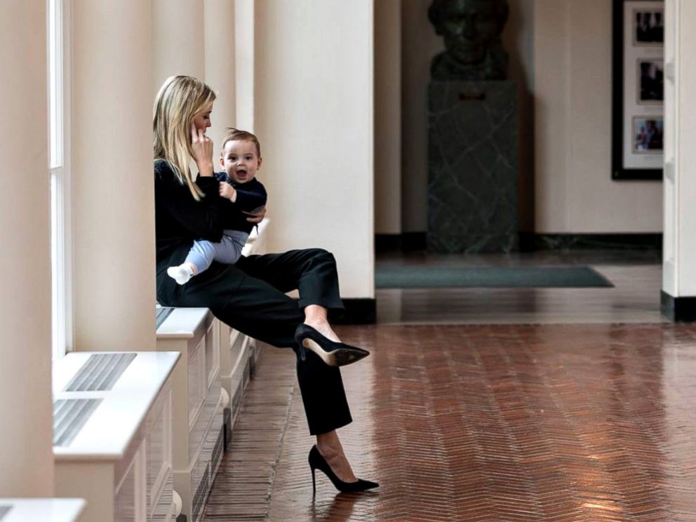 PHOTO: Holding her youngest son Theodore, Ivanka Trump talks on the phone in the East Colonnade of the White House, Jan. 29, 2017, in Washington.