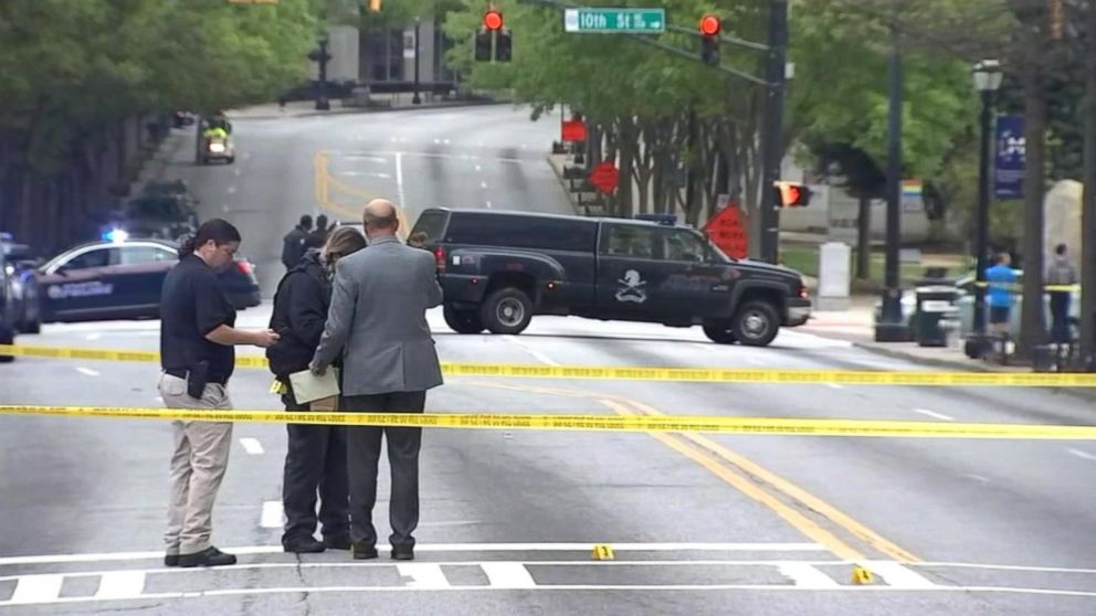 PHOTO: This still from video shows police investigating the "targeted" killing of a woman in broad daylight by a gunman on a busy Midtown Atlanta street, Apr. 3, 2017.