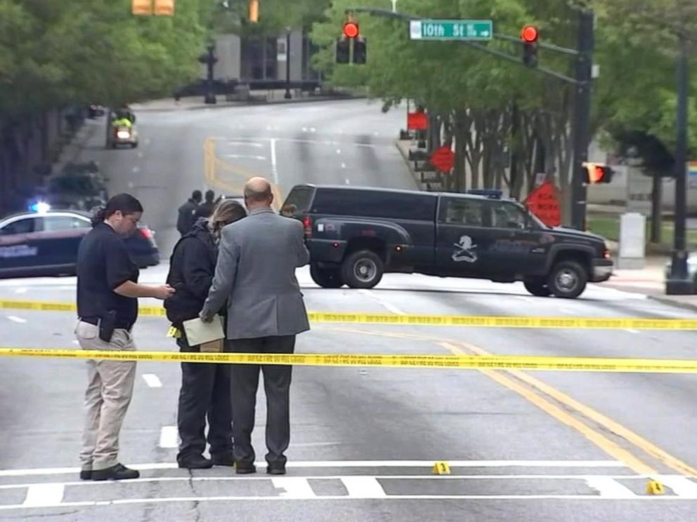 PHOTO: This still from video shows police investigating the targeted killing of a woman in broad daylight by a gunman on a busy Midtown Atlanta street, Apr. 3, 2017.