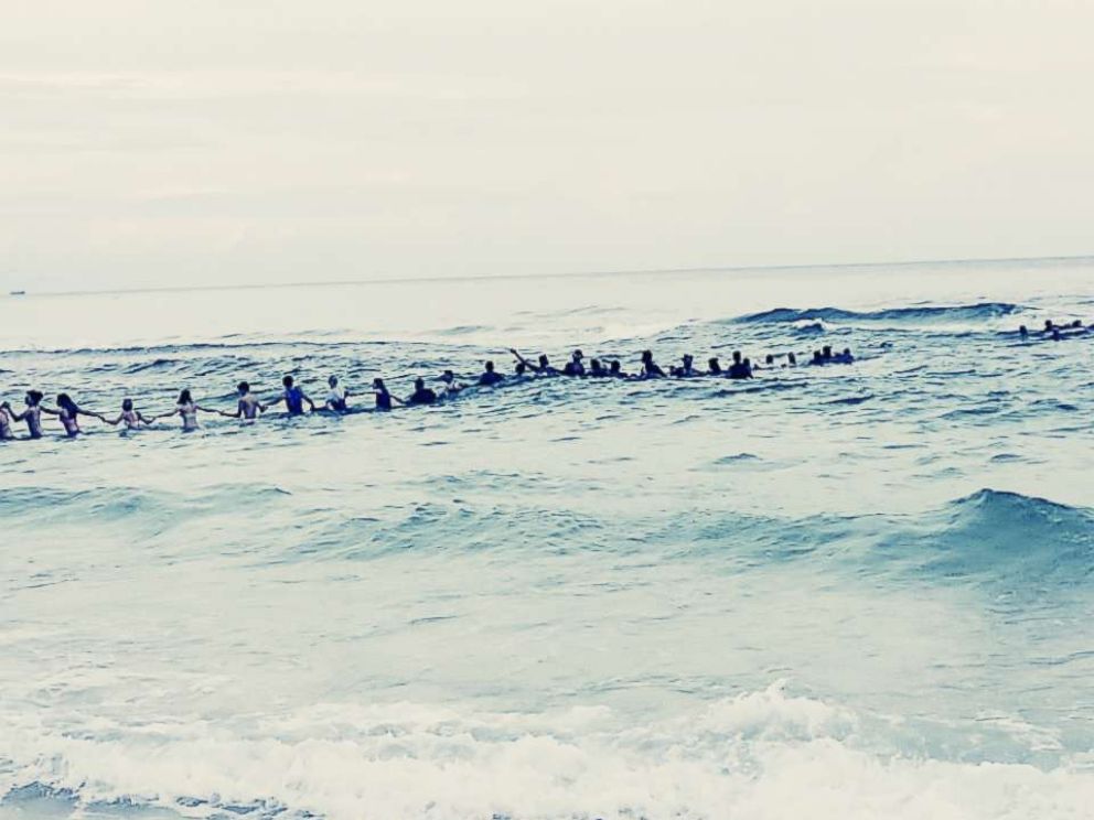 PHOTO: A group of strangers linked arms and waded into the ocean to rescue a group of swimmers stranded off the coast of Panama City Beach, Fla.