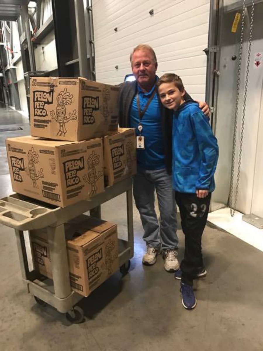 PHOTO: The general manger of the local Hershey distribution factory, Ed Ehrenberger, help Tryston and Anissa Brown load the boxes of donated chocolates into their car on Monday. 