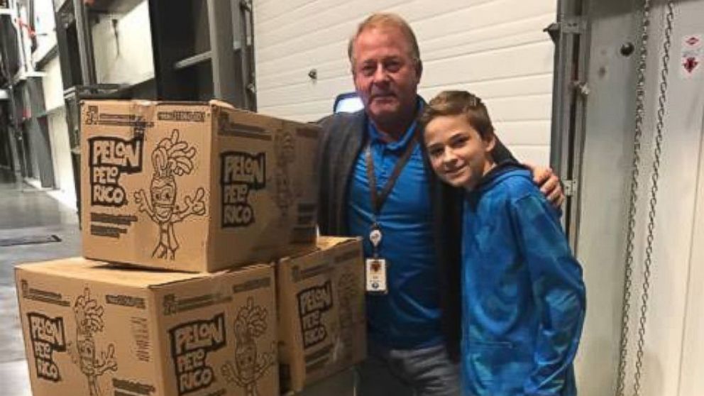 PHOTO: The general manger of the local Hershey distribution factory, Ed Ehrenberger, help Tryston and Anissa Brown load the boxes of donated chocolates into their car on Monday. 