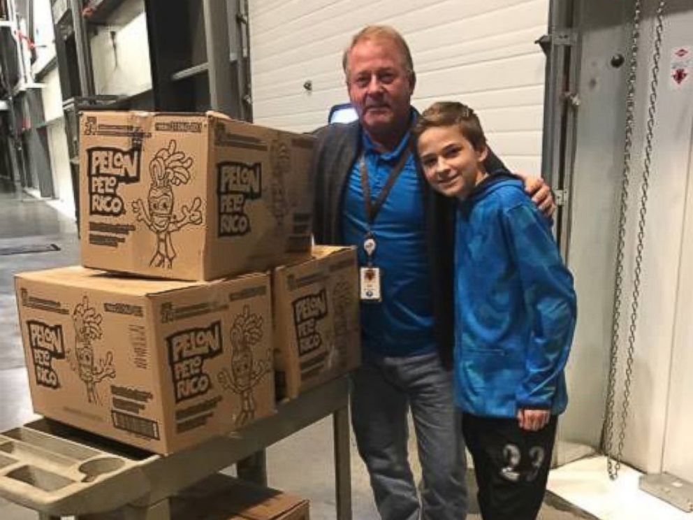 PHOTO: The general manger of the local Hershey distribution factory, Ed Ehrenberger, help Tryston and Anissa Brown load the boxes of donated chocolates into their car on Monday.