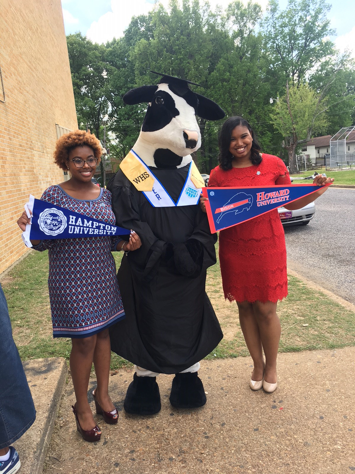 PHOTO: MacKenzie Walker, left, holds up her Hampton University banner, while her classmate, Cassietta Jones, right, holds up her Howard University banner. 