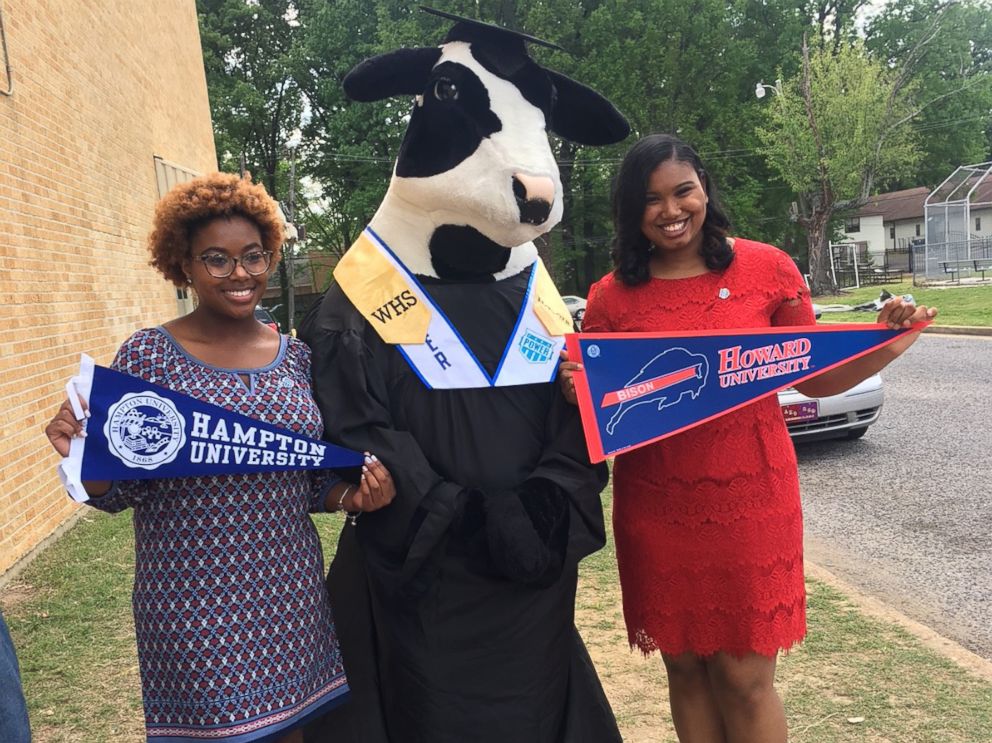 PHOTO: MacKenzie Walker, left, holds up her Hampton University banner, while her classmate, Cassietta Jones, right, holds up her Howard University banner.