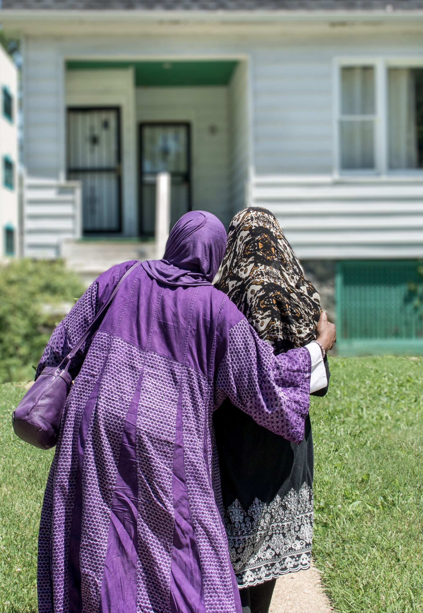 PHOTO: Asma Inge Hanif escorting a woman into the Muslimat Al Nisaa, a homeless shelter for Muslim women that Hanif runs out of her home. 