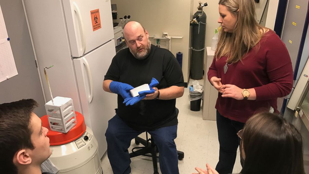 Dr. Fultz, research adviser and MSU Biology professor, with student researchers, Will Casto and Danielle Gibson, taking smooth muscle cells out of liquid nitrogen with SpaceTango Biomedical engineer, Gentry Barnett.