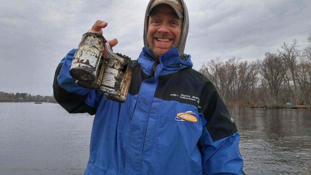 PHOTO: Andy Holst holds the Budweiser beer cans he and friends caught in Wisconsin's Wolf River on April 17. Budweiser officials say the cans, caught in Wisconsin's Wolf River, date back to at least 60 years.