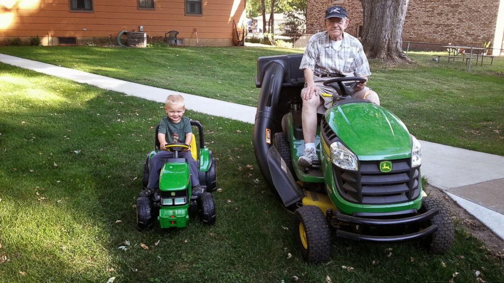 Emmett, left and Erling pose for a picture in their matching tractors.
