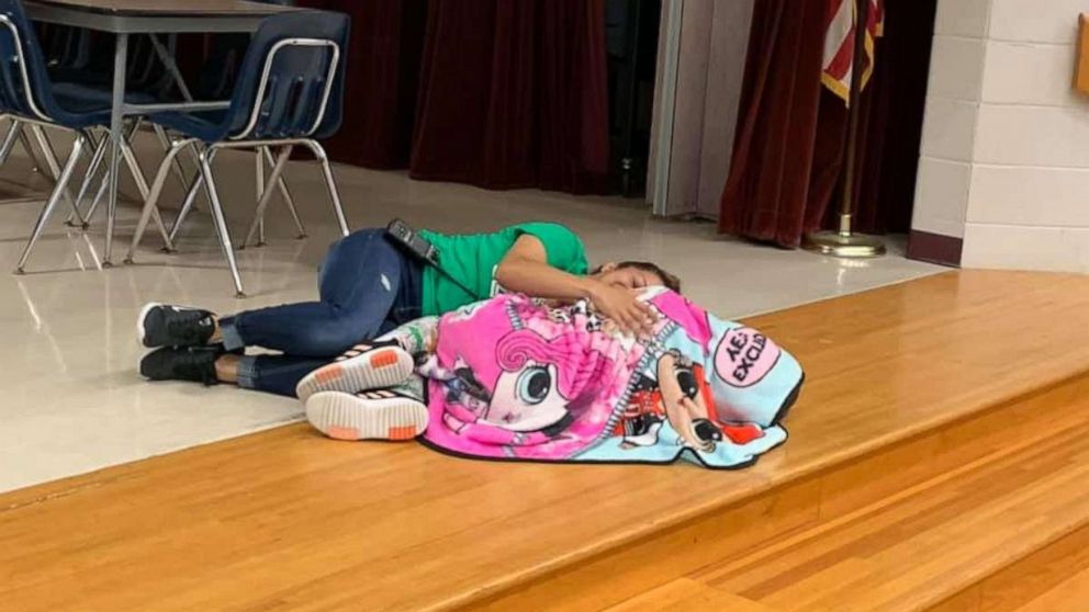 PHOTO: Custodian Esther McCool laid down with a student at Passmore Elementary School in Alvin, Texas.