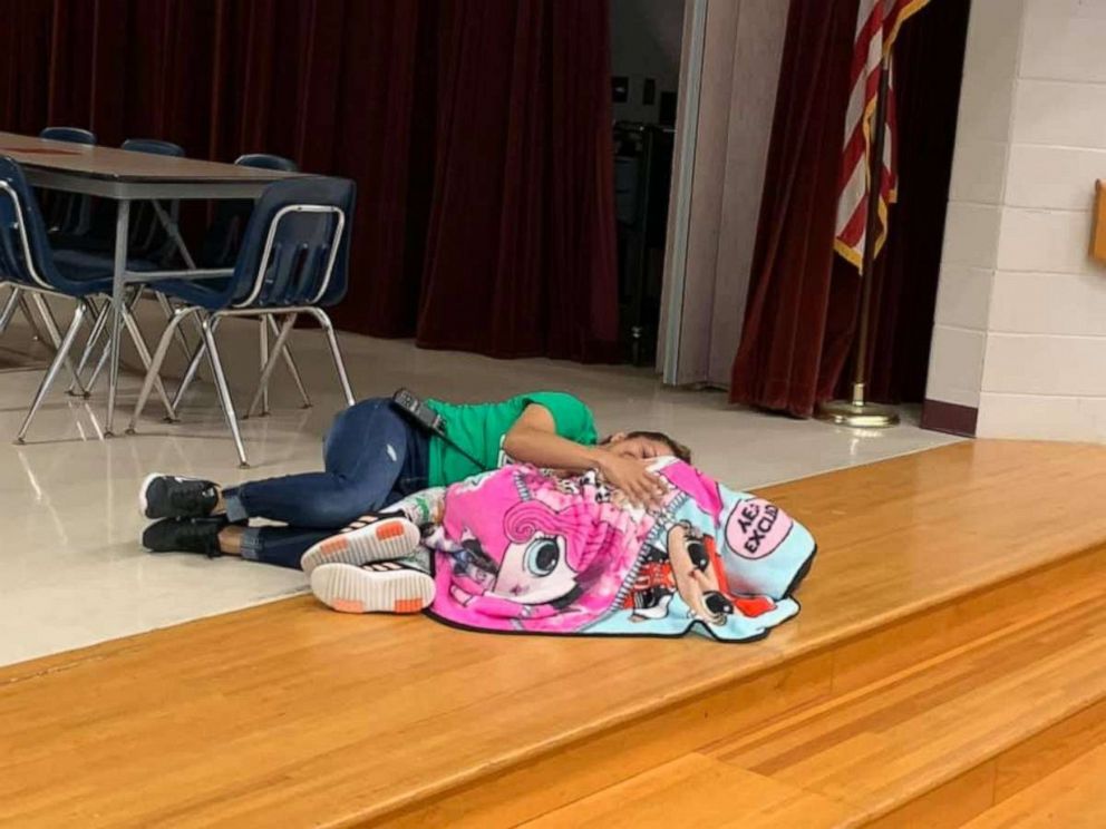 PHOTO: Custodian Esther McCool laid down with a student at Passmore Elementary School in Alvin, Texas.