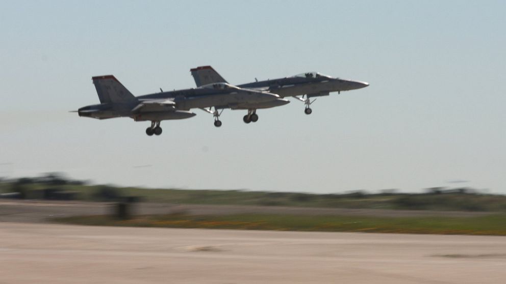 A pair of F/A-18C "Hornet" jets launch from the Marine Corps Air Station Miramar flight line, Feb. 12, to join a formation of about 190 aircraft to participate in the Centennial of Naval Aviation "Parade of Flight." The event featured static displays, stunt motorcycle riders and demonstrations from special operations forces in addition to the parade.