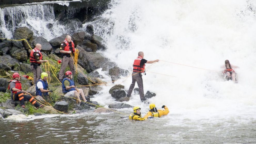 PHOTO: Rescuers work to pull people from the water after a boat went over Lake Linganore Dam in Maryland, June 27, 2015.