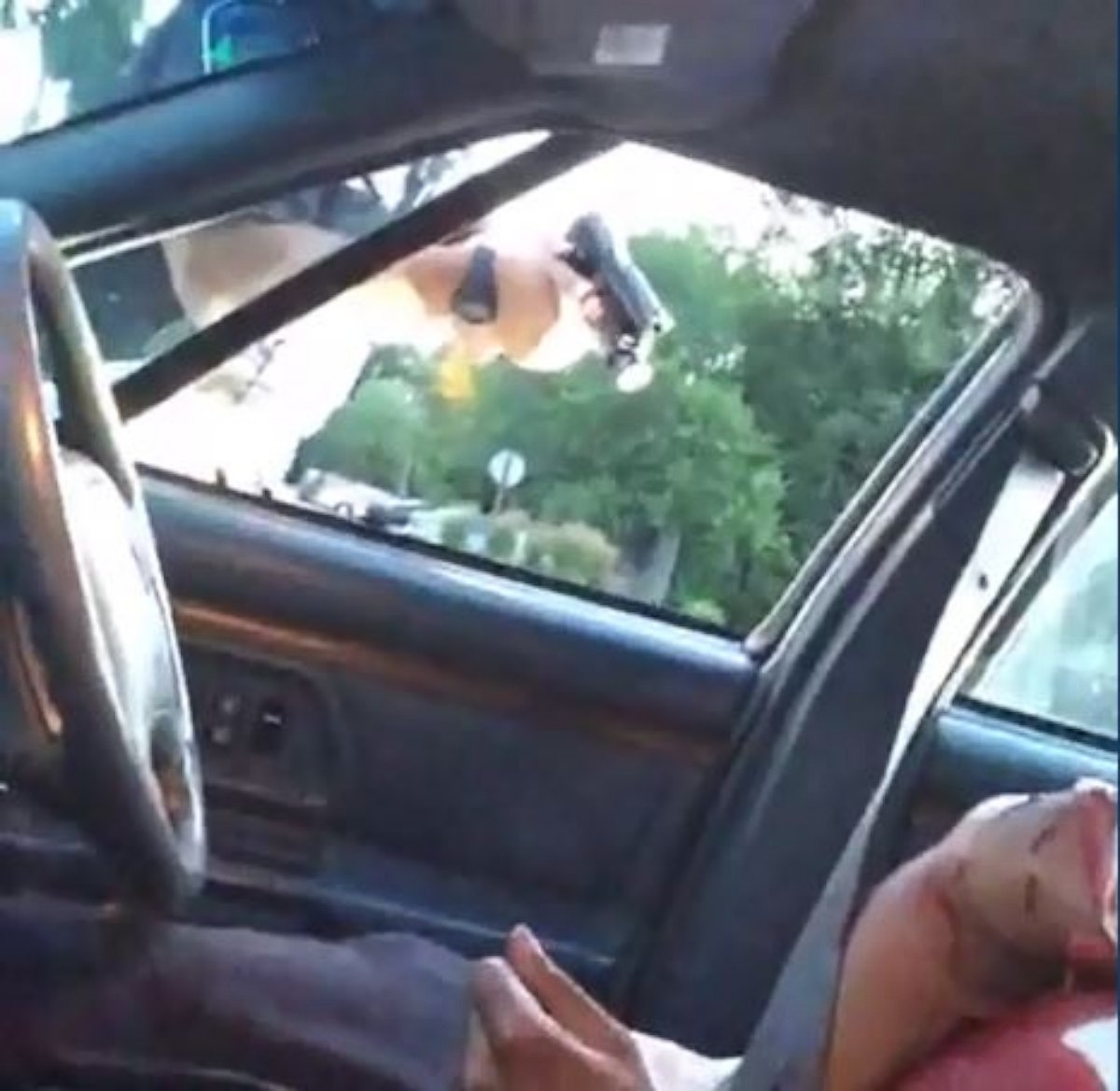 PHOTO: Cell phone footage seen here shows the victim bleeding heavily in the passenger seat of a vehicle. The officer can be seen pointing a gun through the window in Falcon Heights, Minnesota, July, 6, 2016.