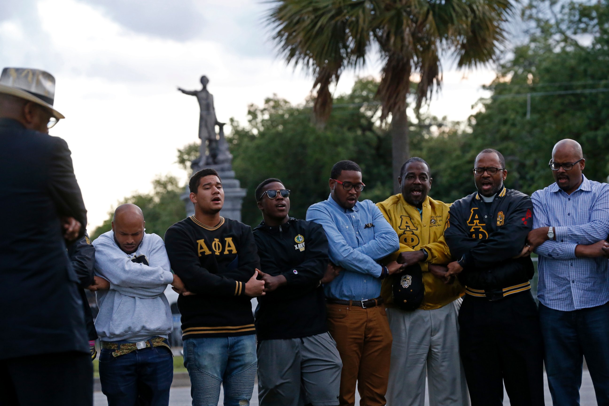 PHOTO: Graduate members of Alpha Phi Alpha Fraternity pray during a "social action prayer vigil" across the street from the Jefferson Davis monument in New Orleans, Thursday, May 4, 2017. 