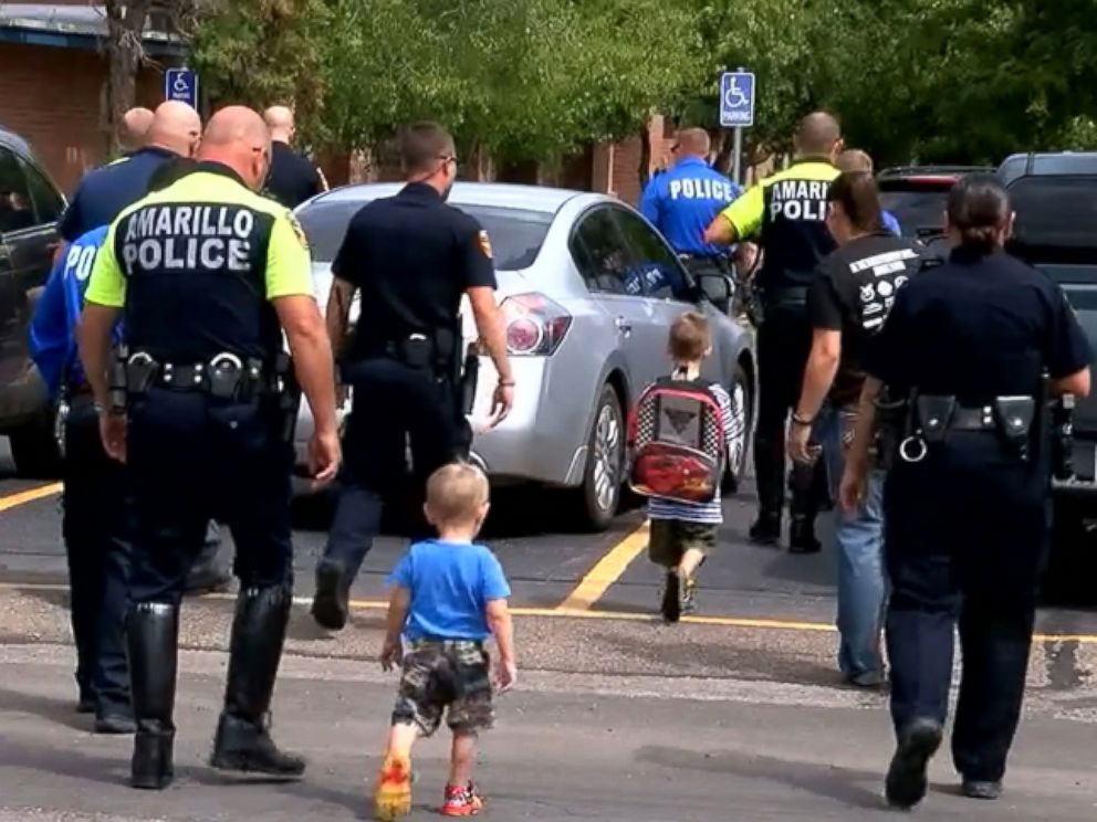 PHOTO: Nearly two dozen police officers from the Amarillo Police Department in Texas surprised and escorted a fallen comrade's children on their first day of school on Aug. 22, 2016.