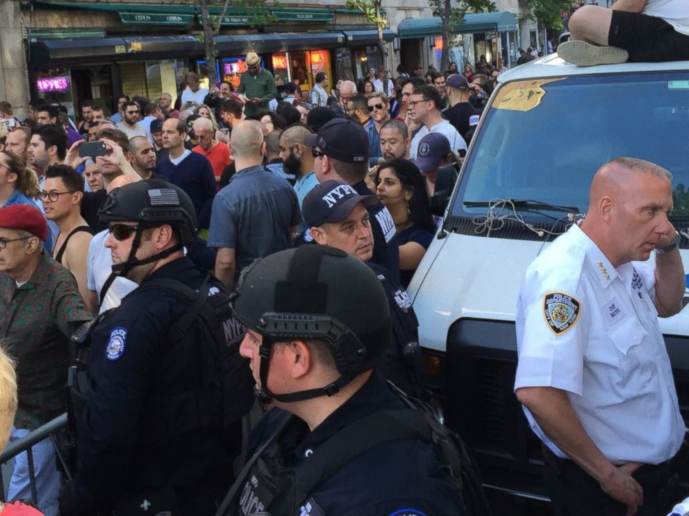 PHOTO: People gather outside the Stonewall Inn in New York City to pay tribute to the victims of a mass shooting at a gay club in Orlando, June 12, 2016.