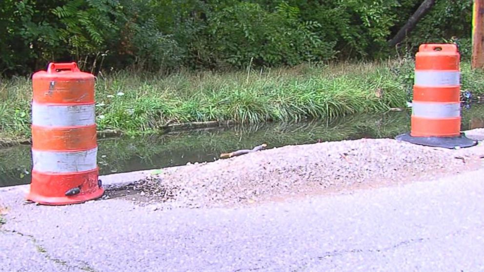 PHOTO: Residents turn a sinkhole into a fishing hole on Hull Street and McNichols in Detroit, Mich. on Aug. 24, 2015.