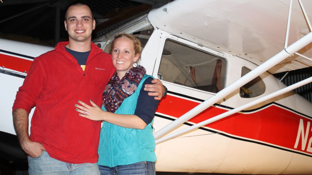 Mollie-Jean Burgess and Luke DeLisio show off the ring after their mid-flight engagement.